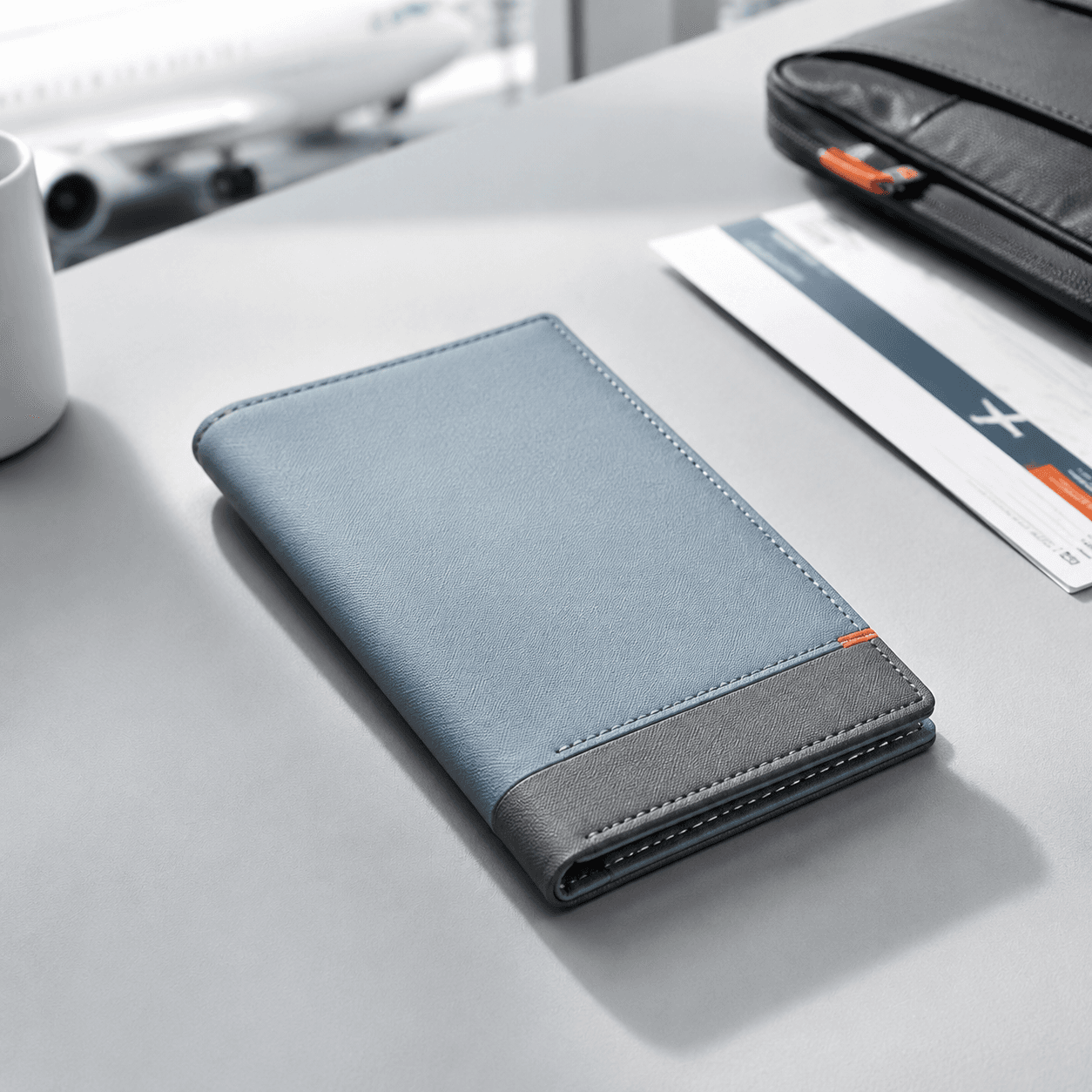 Fog-blue passport wallet closed flat on a neutral studio backdrop